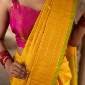 A Double warp kanjivaram light weight silk saree with a broad check border & dual shaded pallu