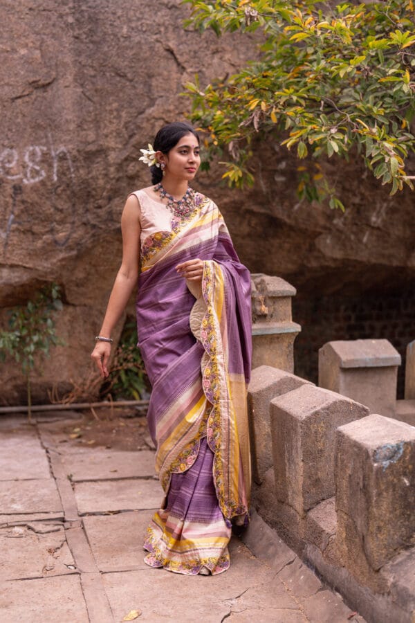 A classic kanjivaram saree with a monochromatic shades of lilac with a contrast multi colour horizontal stripe border - Image 5