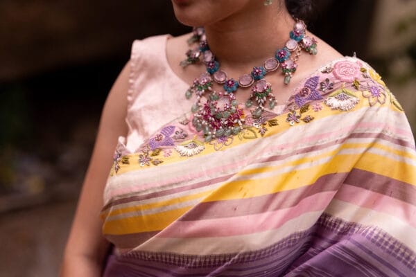 A classic kanjivaram saree with a monochromatic shades of lilac with a contrast multi colour horizontal stripe border - Image 2