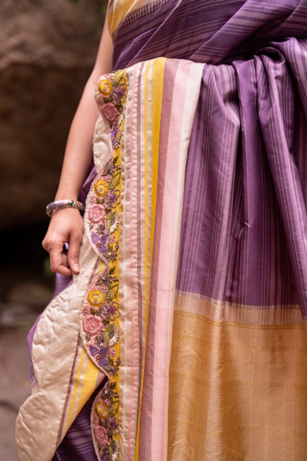 A classic kanjivaram saree with a monochromatic shades of lilac with a contrast multi colour horizontal stripe border - Image 3
