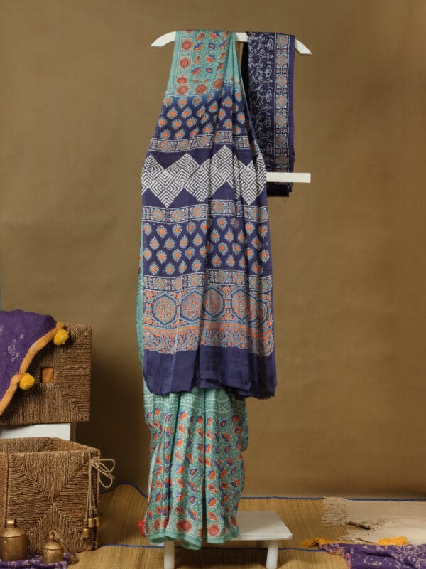A modal silk with ajrakh prints in a pastel shade with a contrast pallu