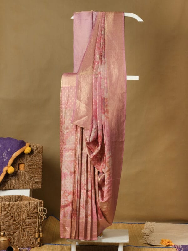 A tissue banarasi saree with floral digital print motifs with a plain tissue blouse.