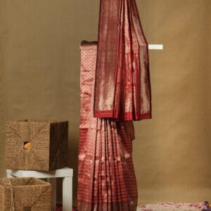 A Banarasi silk with a vertical stripe hand woven design with a zari pallu elevates the look.