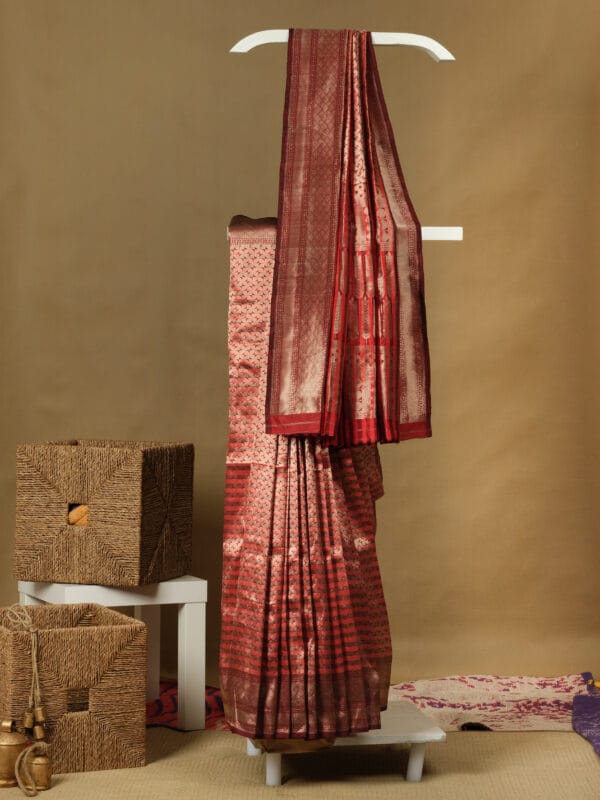A Banarasi silk with a vertical stripe hand woven design with a zari pallu elevates the look.